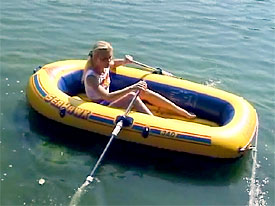 Naked girl on inflatable boat