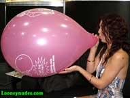 Karlie blows up balloon