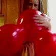 Kayla Karlsen blows up balloon
